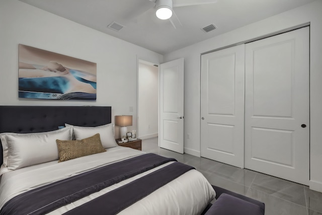 bedroom featuring tile patterned floors, ceiling fan, and a closet