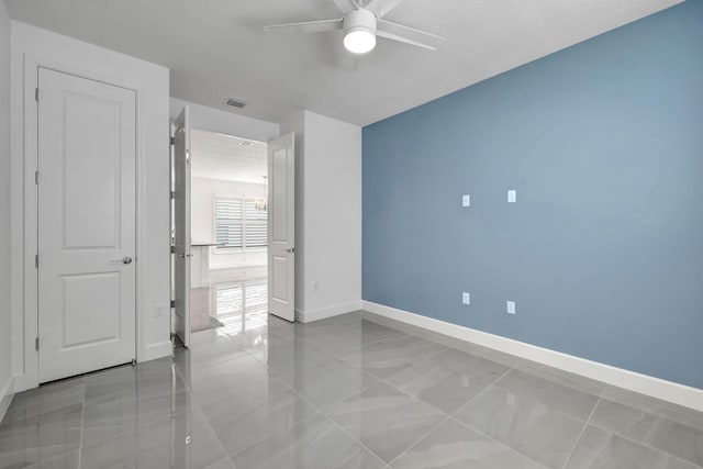 unfurnished bedroom featuring ceiling fan and light tile patterned flooring