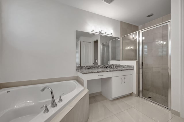 bathroom featuring vanity and independent shower and bath