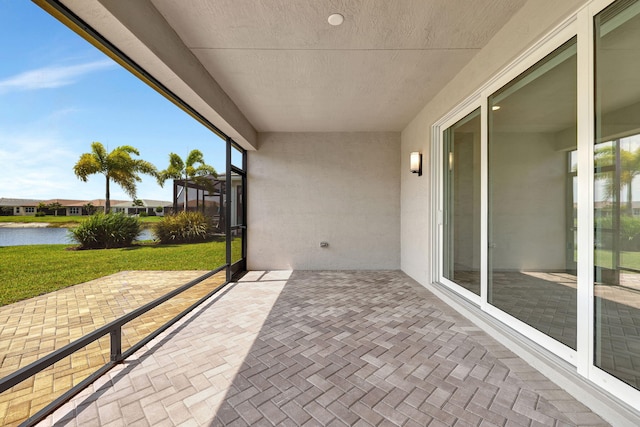 unfurnished sunroom with a water view