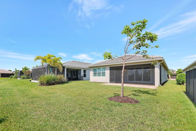 rear view of property featuring a yard and a lanai