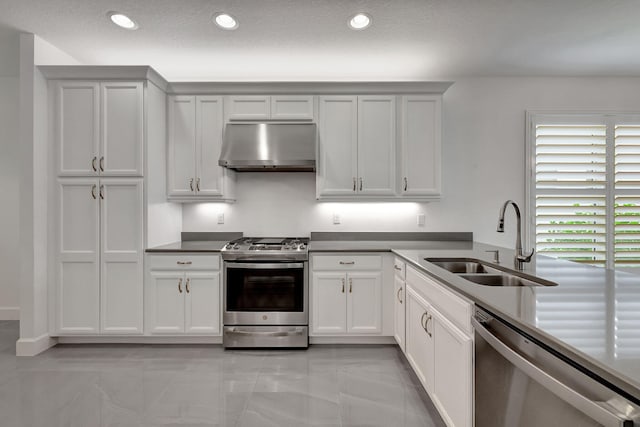 kitchen with exhaust hood, sink, a textured ceiling, white cabinetry, and stainless steel appliances