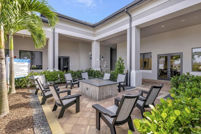 view of patio / terrace with french doors and a fire pit