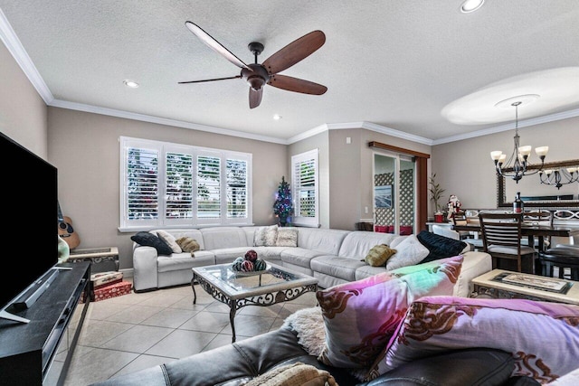 tiled living room with crown molding, ceiling fan with notable chandelier, and a textured ceiling