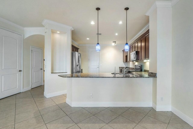 kitchen featuring pendant lighting, crown molding, dark stone countertops, stainless steel appliances, and kitchen peninsula