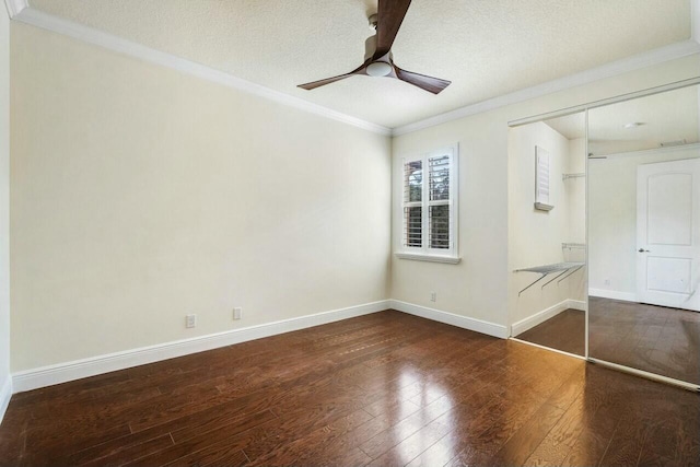 unfurnished room featuring dark hardwood / wood-style flooring, ceiling fan, crown molding, and a textured ceiling