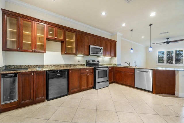 kitchen featuring wine cooler, appliances with stainless steel finishes, decorative light fixtures, and sink