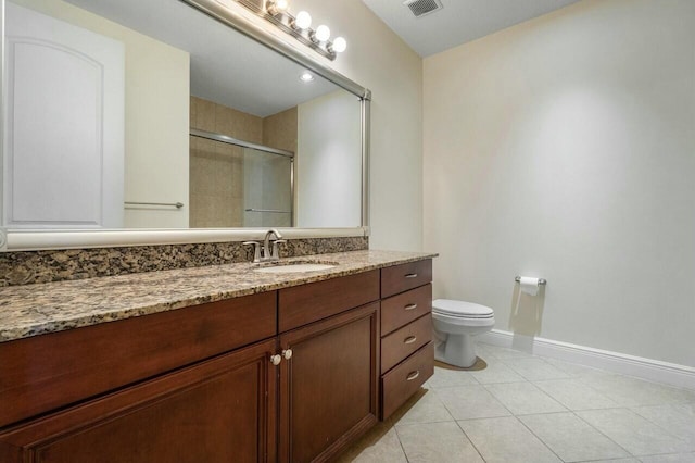 bathroom featuring an enclosed shower, vanity, tile patterned floors, and toilet