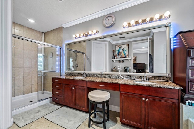 bathroom featuring ornamental molding, vanity, and a shower with shower door