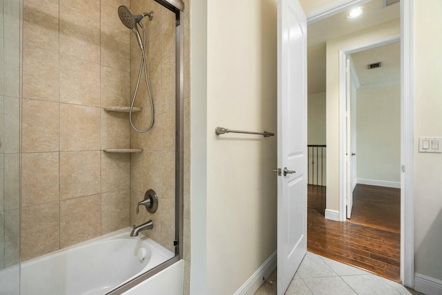 bathroom featuring tile patterned floors and tiled shower / bath combo