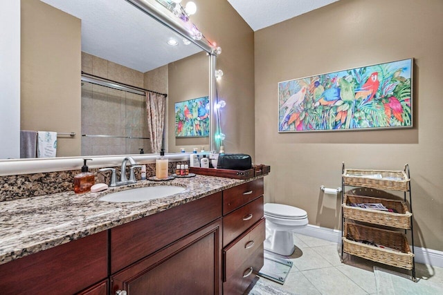 bathroom with walk in shower, vanity, toilet, and tile patterned flooring