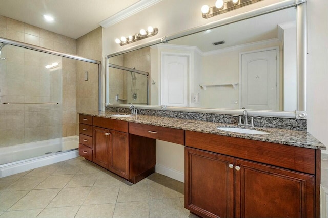 bathroom featuring ornamental molding, a shower with shower door, tile patterned flooring, and vanity