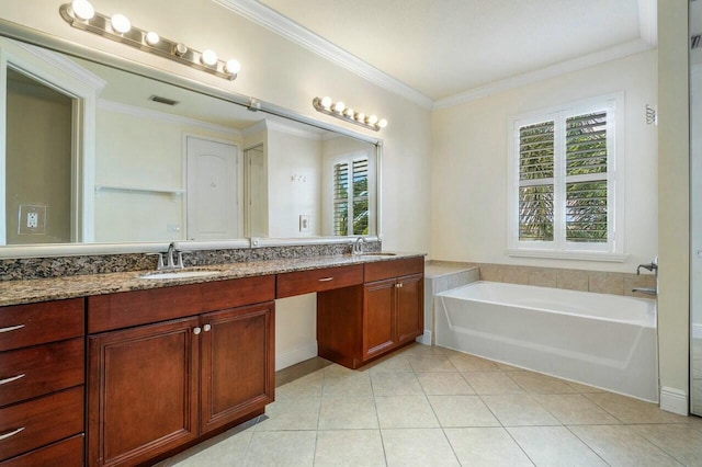 bathroom with tile patterned flooring, a bathing tub, a wealth of natural light, and vanity