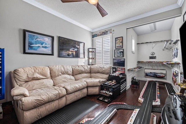 living room featuring dark wood-type flooring, ceiling fan, crown molding, and a textured ceiling