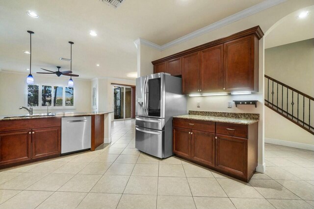 kitchen with sink, light tile patterned floors, ornamental molding, kitchen peninsula, and stainless steel appliances