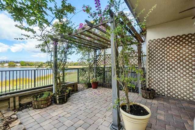 view of patio / terrace featuring a water view and a pergola