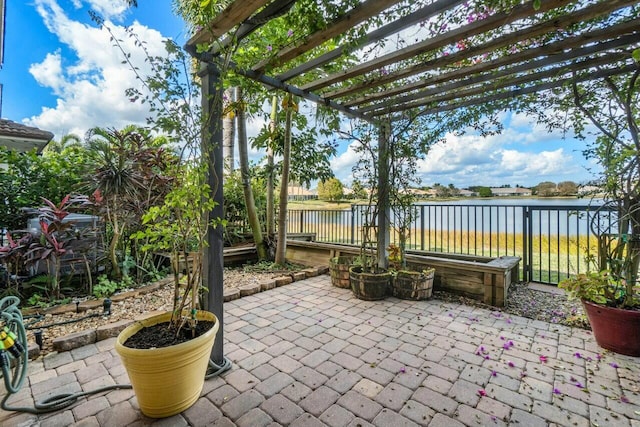 view of patio / terrace with a water view and a pergola