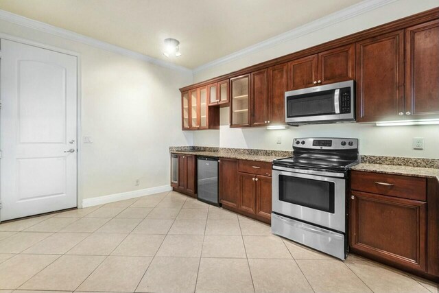 kitchen featuring light tile patterned flooring, appliances with stainless steel finishes, beverage cooler, and light stone countertops