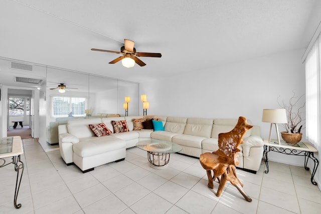 living room with ceiling fan and light tile patterned floors