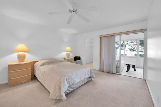 carpeted bedroom featuring ceiling fan, a spacious closet, and a closet