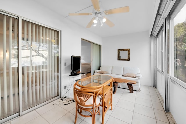 sunroom / solarium featuring ceiling fan