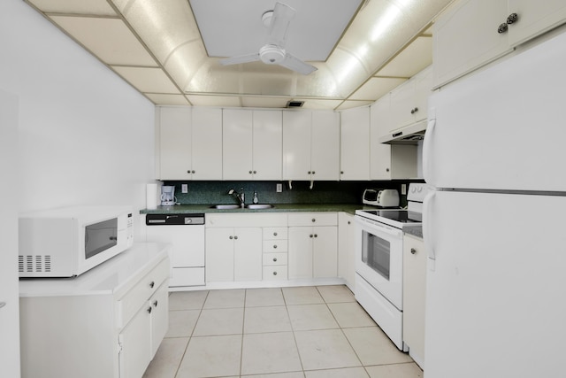 kitchen with white appliances, sink, tasteful backsplash, light tile patterned flooring, and white cabinetry