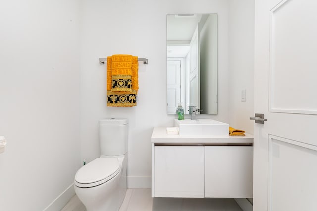 bathroom featuring tile patterned floors, vanity, and toilet