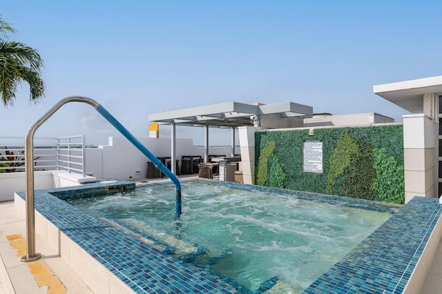 view of swimming pool featuring a hot tub