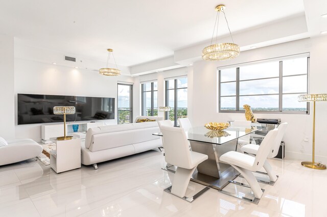 dining area with a healthy amount of sunlight and a notable chandelier