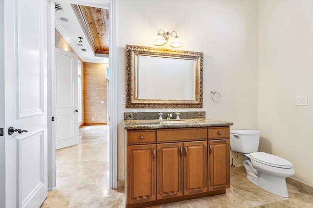 bathroom featuring vanity, toilet, and crown molding