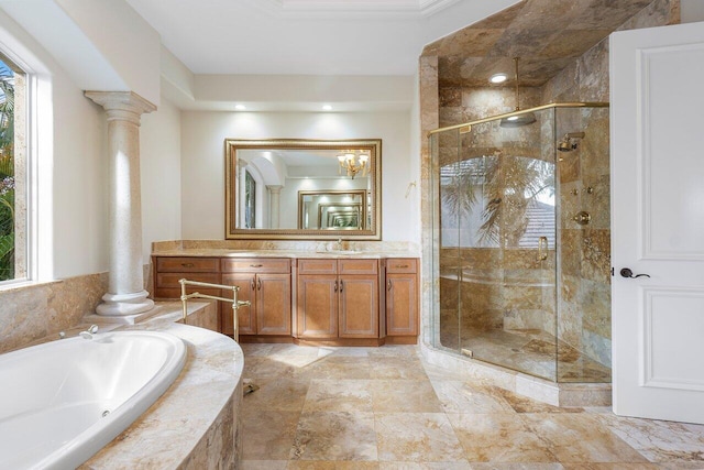 bathroom featuring plenty of natural light, separate shower and tub, vanity, and decorative columns