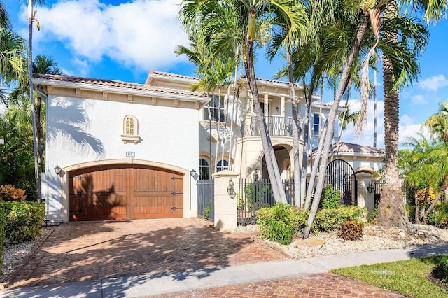 mediterranean / spanish-style house with a balcony and a garage