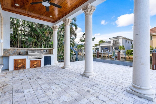 view of patio with ceiling fan, sink, a grill, area for grilling, and a dock