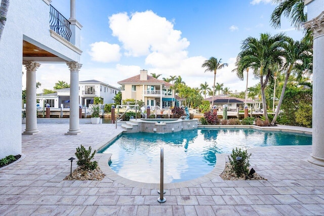 view of swimming pool with an in ground hot tub