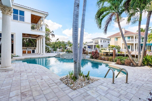 view of pool with an in ground hot tub, a patio, and area for grilling