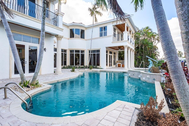 view of swimming pool with french doors