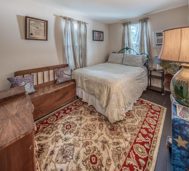 bedroom with dark hardwood / wood-style floors