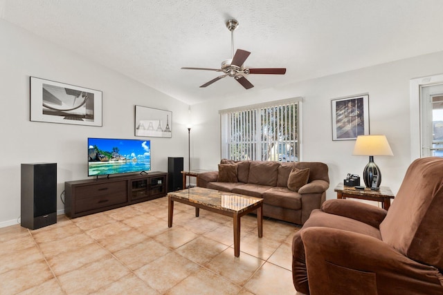 tiled living room with a textured ceiling, vaulted ceiling, ceiling fan, and a healthy amount of sunlight