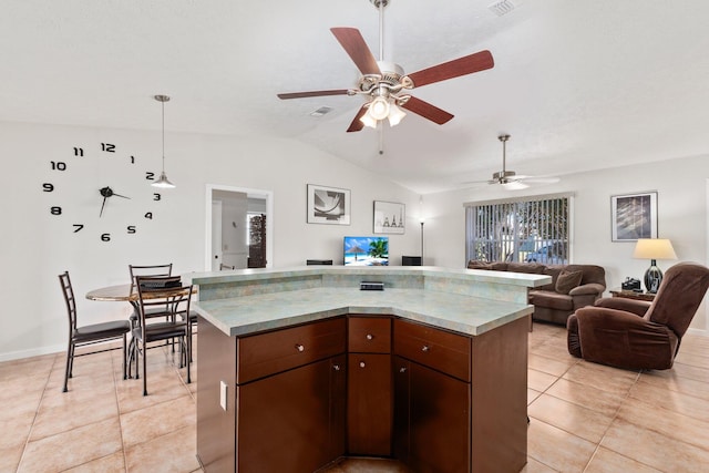 kitchen featuring vaulted ceiling, ceiling fan, light tile patterned floors, decorative light fixtures, and a kitchen island