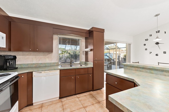 kitchen with white appliances, a textured ceiling, sink, pendant lighting, and light tile patterned flooring