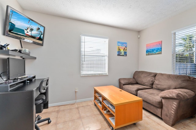 office with light tile patterned floors and a textured ceiling