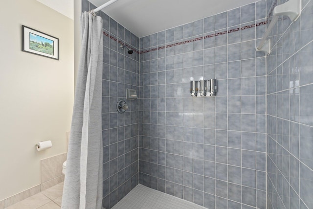 bathroom with a shower with shower curtain and tile patterned flooring