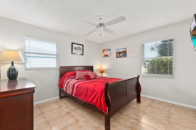 bedroom featuring light tile patterned floors, a textured ceiling, and ceiling fan