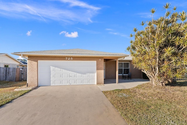 single story home with a garage and a front lawn