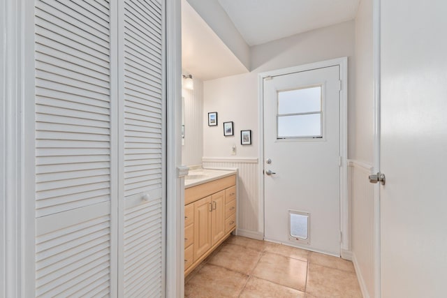 bathroom with tile patterned flooring and vanity