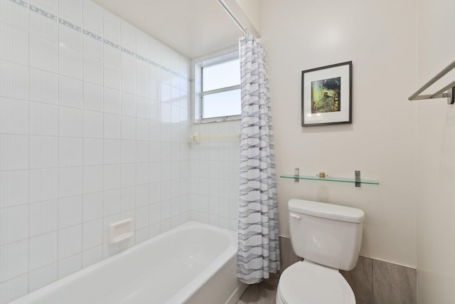 bathroom featuring shower / tub combo and toilet