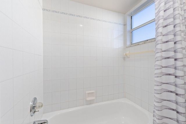 bathroom featuring shower / tub combo with curtain