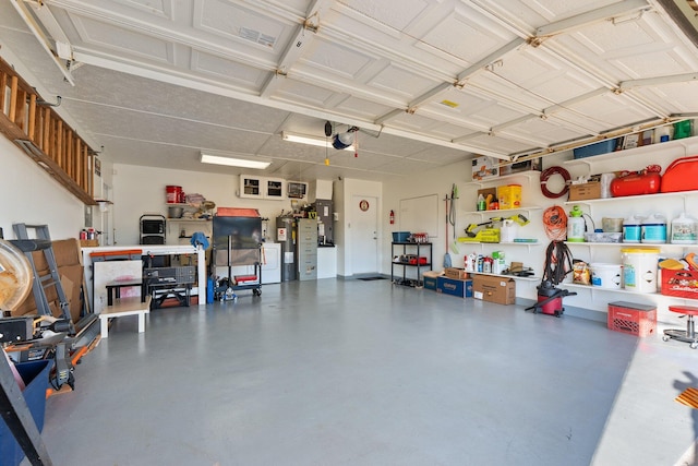 garage featuring electric water heater and a garage door opener