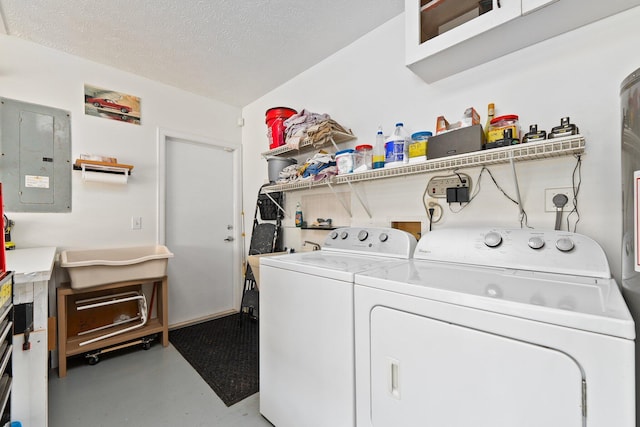 laundry room with washing machine and dryer, a textured ceiling, and electric panel