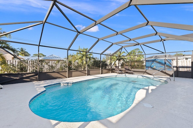 view of pool with a patio area and a lanai